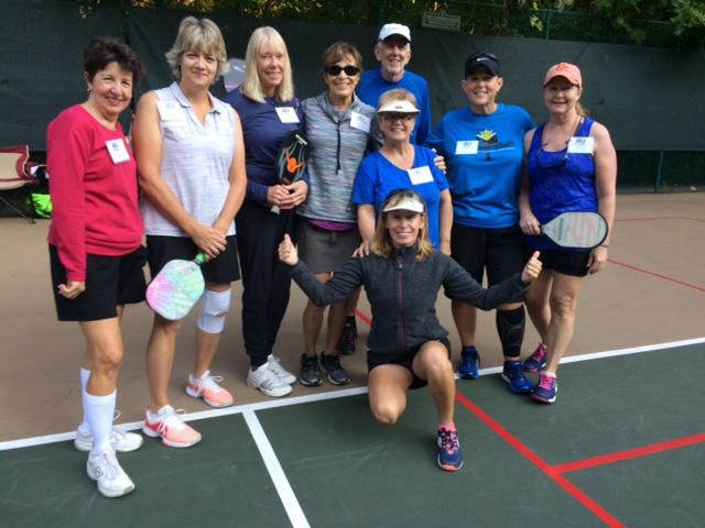 group photo by the pickleball courtside