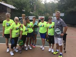 group photo of pickleball instructor with his students